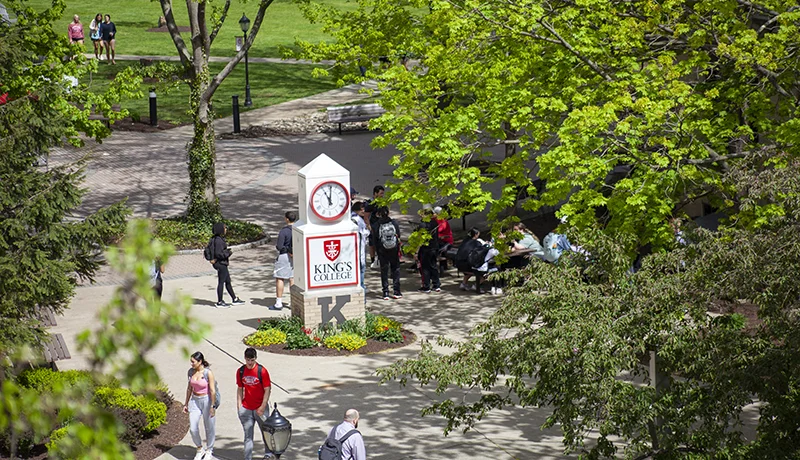 students lining up for commencement, celebrated by members of the graduate admissions office