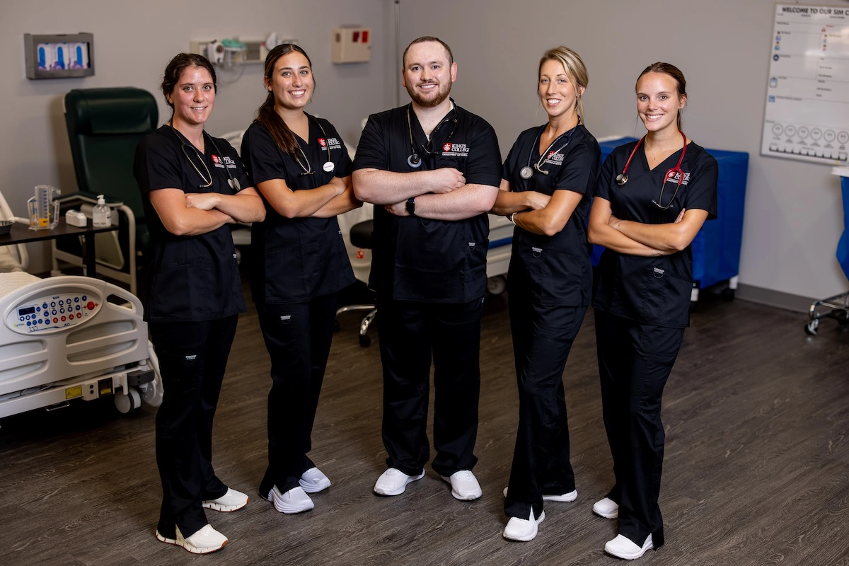 nursing students stand shoulder to shoulder