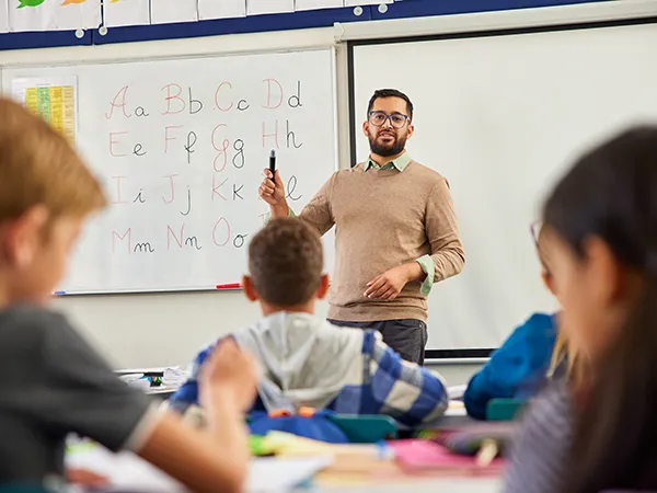 a professor teaching a class in an education classroom, an example of what you can do after a reading specialist masters program