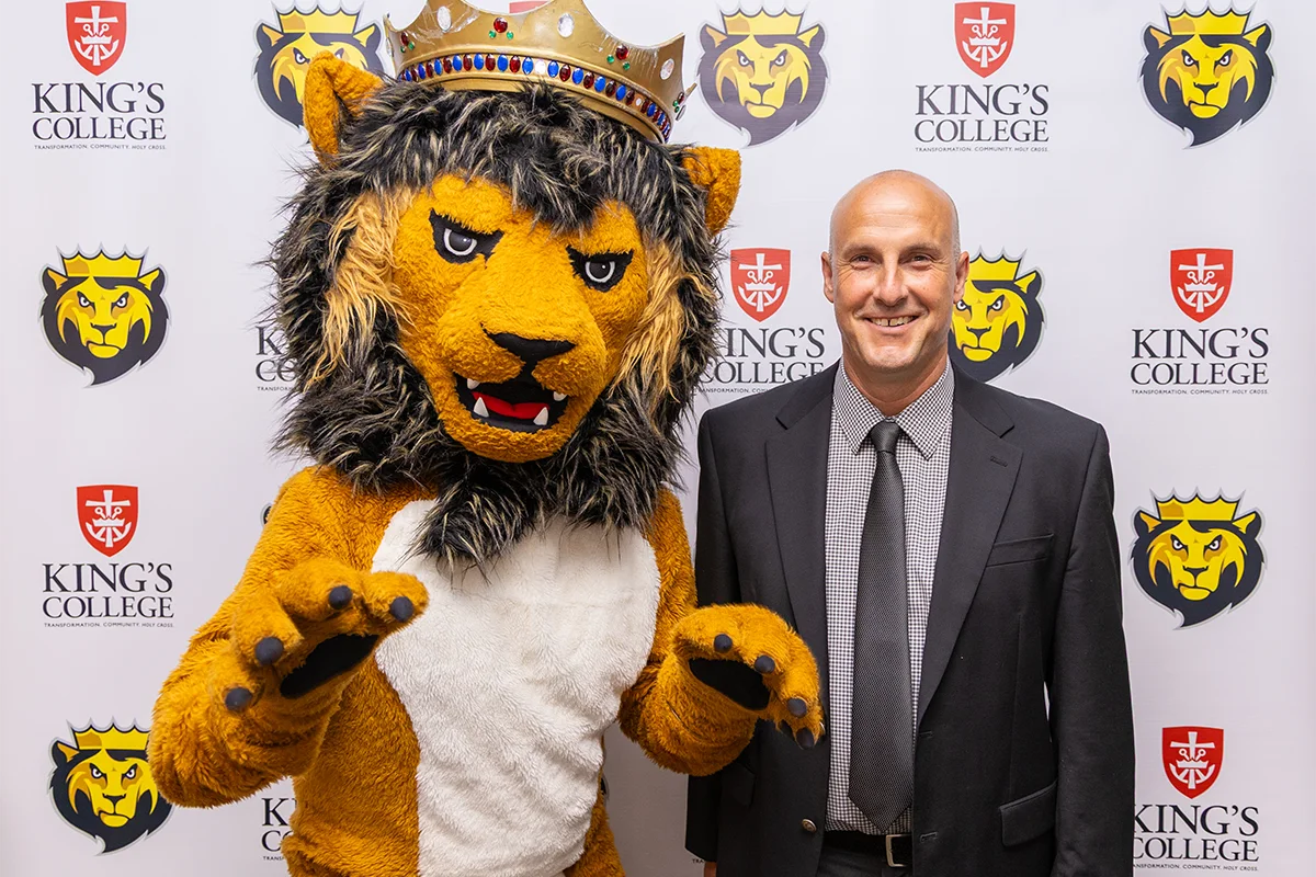 Coach Orlowski posing with Mascot Leo