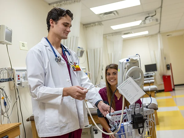students using medical equipment, earning their physician assistant degree