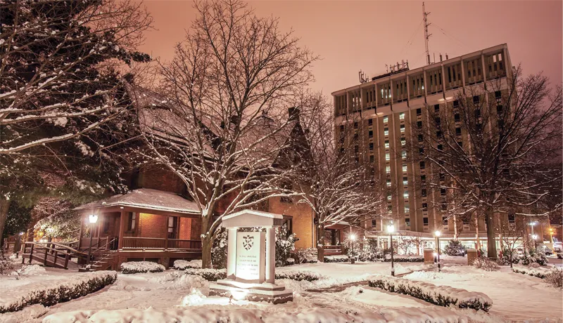 center of campus at night in the snow